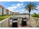 Community grilling area with two gas grills overlooking a lake at 19029 Us Highway 19 N # 19C, Clearwater, FL 33764