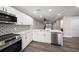 Updated kitchen showcasing stainless steel appliances and white cabinets with wood grain floors at 19029 Us Highway 19 N # 19C, Clearwater, FL 33764