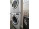 Efficient laundry area with a stacked washer/dryer unit and water heater maximizing space in the home at 19029 Us Highway 19 N # 19C, Clearwater, FL 33764