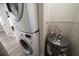 Compact laundry area with a stacked washer and dryer and a space-saving water heater at 19029 Us Highway 19 N # 19C, Clearwater, FL 33764