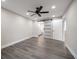 Spacious main bedroom featuring a ceiling fan, recessed lighting, and a modern sliding barn door to the ensuite bathroom at 19029 Us Highway 19 N # 19C, Clearwater, FL 33764