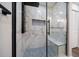 This luxurious shower boasts marble walls, a built-in bench, rainfall showerhead, and mosaic tile flooring at 19029 Us Highway 19 N # 19C, Clearwater, FL 33764