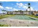 Exterior view of shuffleboard court with tropical landscaping and residential building in the background at 19029 Us Highway 19 N # 19C, Clearwater, FL 33764