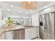 Modern kitchen with stainless steel appliances, granite countertops, and a view of the living room and waterfront at 2 Adalia Ave # 602, Tampa, FL 33606