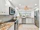 Well-lit kitchen featuring stainless steel appliances, granite countertops, and white cabinetry at 2 Adalia Ave # 602, Tampa, FL 33606