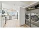 Modern kitchen with stainless steel appliances, island sink, white cabinets, adjacent to washer and dryer at 2 Adalia Ave # 602, Tampa, FL 33606