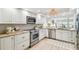 Updated kitchen with stainless steel appliances, granite countertops, and contemporary design at 2 Adalia Ave # 602, Tampa, FL 33606