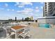 Poolside area with patio furniture, lounge chairs, umbrellas, and a view of the city skyline at 2 Adalia Ave # 602, Tampa, FL 33606