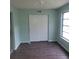 Bedroom features fresh paint, modern wood-look floors, closet, and natural light at 2043 Denmark St # 77, Clearwater, FL 33763