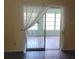 Sunroom access off of the bedroom with a large sliding glass door and sheer drapery at 2043 Denmark St # 77, Clearwater, FL 33763