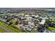 Wide aerial view of community featuring swimming pool, pickleball courts, lake and parking at 2218 Mayfield Palms Ln # 323, Sun City Center, FL 33573
