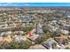 A neighborhood view showcasing mature landscaping, ponds, and a golf course in the distance at 2218 Mayfield Palms Ln # 323, Sun City Center, FL 33573