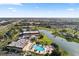Birds-eye view showcasing community with pool, lake, and surrounding residential area at 2218 Mayfield Palms Ln # 323, Sun City Center, FL 33573