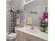 Well-lit bathroom with a single sink, framed mirror, and shower-tub combination at 2218 Mayfield Palms Ln # 323, Sun City Center, FL 33573
