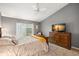 This bedroom features neutral tones, large dresser, and window with natural light at 2218 Mayfield Palms Ln # 323, Sun City Center, FL 33573