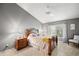 Cozy bedroom features a neutral color scheme, and ample natural light from the window at 2218 Mayfield Palms Ln # 323, Sun City Center, FL 33573