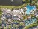 Aerial view of the community clubhouse, pool, tennis courts, and manicured grounds at 2218 Mayfield Palms Ln # 323, Sun City Center, FL 33573