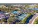 Aerial view of the pool, clubhouse, parking, and pickle ball courts at 2218 Mayfield Palms Ln # 323, Sun City Center, FL 33573