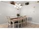 Cozy dining area featuring a wooden table, white chairs, and decorative accents on the high shelf at 2218 Mayfield Palms Ln # 323, Sun City Center, FL 33573