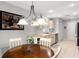 Dining area with chandelier and neutral cabinets at 2218 Mayfield Palms Ln # 323, Sun City Center, FL 33573