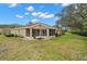 Rear view of the property with a screened lanai and well-maintained landscaping at 2218 Mayfield Palms Ln # 323, Sun City Center, FL 33573