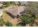 A rear aerial view of the home showcasing the screened in patio and mature landscaping at 2218 Mayfield Palms Ln # 323, Sun City Center, FL 33573