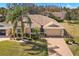 Charming single-story home with a well-maintained lawn, paver driveway, and tropical landscaping at 2218 Mayfield Palms Ln # 323, Sun City Center, FL 33573
