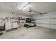 Spacious garage with golf cart, washer, dryer, and ample storage shelving at 2218 Mayfield Palms Ln # 323, Sun City Center, FL 33573