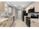 Kitchen featuring neutral cabinets and stainless steel appliances at 2218 Mayfield Palms Ln # 323, Sun City Center, FL 33573