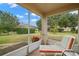 Screened lanai with patio furniture and views of the lush backyard at 2218 Mayfield Palms Ln # 323, Sun City Center, FL 33573