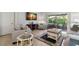 Cozy living room featuring tile floors, neutral furnishings, and sliding glass doors to the outside patio at 2218 Mayfield Palms Ln # 323, Sun City Center, FL 33573