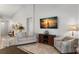 Bright living room with neutral furnishings, tile floors, and modern decor with a sailing theme at 2218 Mayfield Palms Ln # 323, Sun City Center, FL 33573