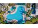 Aerial view of the outdoor swimming pool with lounge chairs and umbrellas at 2218 Mayfield Palms Ln # 323, Sun City Center, FL 33573