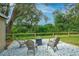 Backyard area with chairs, pea gravel, and wooded view at 2405 Indigo Dr, Clearwater, FL 33763