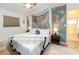 Bedroom showcasing a serene ambiance with a palm leaf accent wall and natural lighting at 2405 Indigo Dr, Clearwater, FL 33763