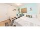 Bright bedroom with colorful rug, blue accent wall, and two twin beds at 2405 Indigo Dr, Clearwater, FL 33763