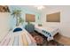 Bright bedroom with colorful rug, blue accent wall, and two twin beds at 2405 Indigo Dr, Clearwater, FL 33763