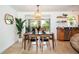 Charming dining area adjacent to kitchen, featuring stylish lighting, and a view of the outdoors at 2405 Indigo Dr, Clearwater, FL 33763