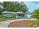 Charming home showcasing well-maintained landscaping, and a welcoming front entrance at 2405 Indigo Dr, Clearwater, FL 33763