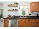 Close-up of a kitchen sink area with stylish fixtures, granite countertops, and modern appliances at 2405 Indigo Dr, Clearwater, FL 33763