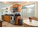 Well-lit kitchen featuring modern appliances, ample cabinet space, and a cozy breakfast table at 2405 Indigo Dr, Clearwater, FL 33763