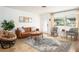 Cozy living room features stylish furniture, a patterned rug, and ample natural light from a large window at 2405 Indigo Dr, Clearwater, FL 33763