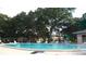 Community swimming pool surrounded by lush trees, offering a refreshing escape at 2405 Indigo Dr, Clearwater, FL 33763