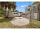 Backyard featuring pea gravel, fire pit, string lights, and palm trees at 2835 Valencia S Way, St Petersburg, FL 33705