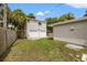 View of the backyard with a two-car garage and lush landscaping at 2835 Valencia S Way, St Petersburg, FL 33705