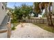 Charming backyard featuring a gravel area with a fire pit and cozy Adirondack chairs at 2835 Valencia S Way, St Petersburg, FL 33705