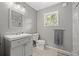 Clean bathroom featuring a vanity with sink, toilet, and a window providing natural light at 2835 Valencia S Way, St Petersburg, FL 33705