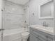Stylish bathroom featuring a tiled shower and tub combo, vanity with sink, and modern fixtures at 2835 Valencia S Way, St Petersburg, FL 33705