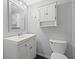 Bright bathroom featuring a white vanity, toilet, mirror, and medicine cabinet offering ample storage at 2835 Valencia S Way, St Petersburg, FL 33705