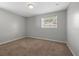 Simple bedroom showcasing neutral walls, carpet, and a window providing natural light at 2835 Valencia S Way, St Petersburg, FL 33705